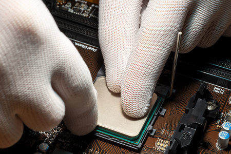 Man hands in gloves replacing processor on the computer motherboard