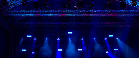 Light beams in blue tones on a live music concert sceneの写真素材