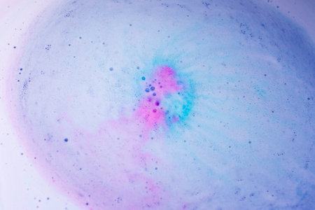 Pastel foam bubbles created by bath bomb dissolving in waterの写真素材