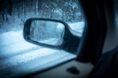 Winter forest scenery reflect in side view car mirror