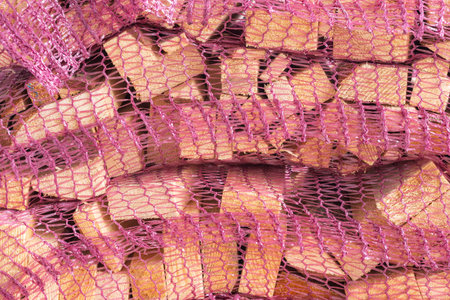 Dried kindling wood in a net bag for starting wood burning stoves