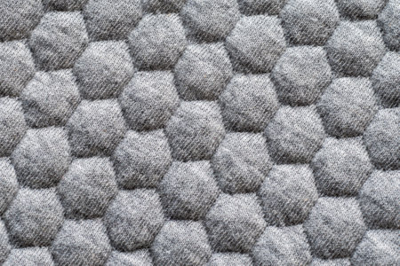 Textured gray fabric with hexagonal mesh patternの写真素材