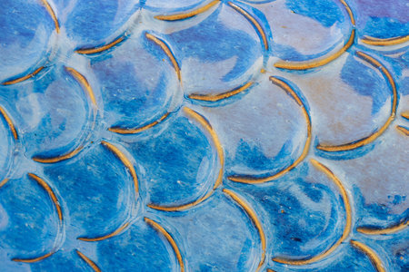 Aqua blue ceramic tile pattern resembling mermaid scales