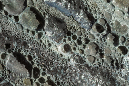 Lunar rocky surface with various sized holes. Full frame abstract backgroundsの写真素材