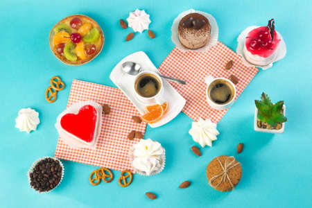 Cake, cups with coffee, cookies on a bright background, morning breakfastの写真素材