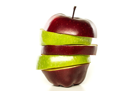 red and green apple sliced sections. Fruit isolated on white background