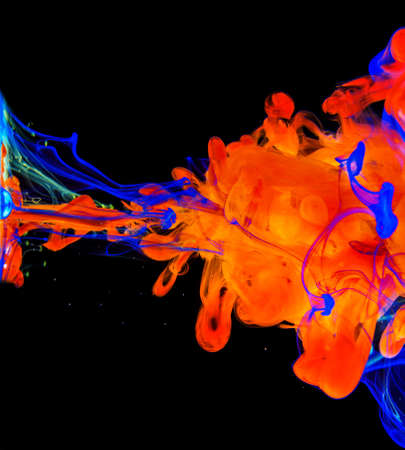 Color paint drops in water. Ink swirling underwater. Cloud of silky ink collision on black background. Colorful abstract smoke explosion animation. Close up camera view.の写真素材
