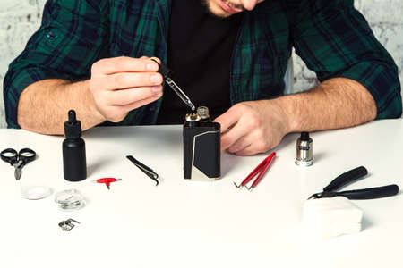 Maintenance of electronic mod vaping device.Modern vaporizer. Start vaping safe ecig vape. Master repair ecigarette close upの写真素材