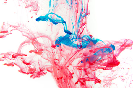 Color paint drops in water. Ink swirling underwater. Cloud of silky ink collision on black...