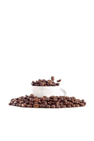 White cup and coffee beans on white backgroundの写真素材