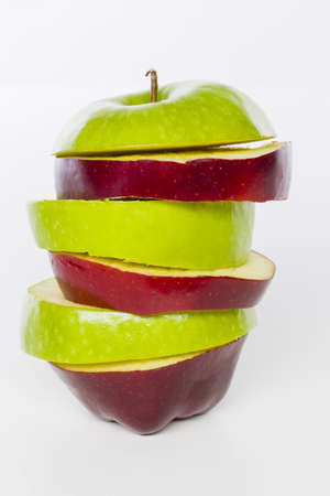 red and green apple sliced sections. Fruit isolated on white backgroundの写真素材