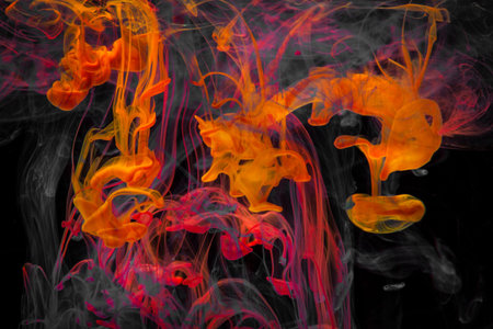 Color paint drops in water. Ink swirling underwater. Cloud of silky ink collision on black...