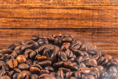 Coffee beans on wood background close-upの写真素材