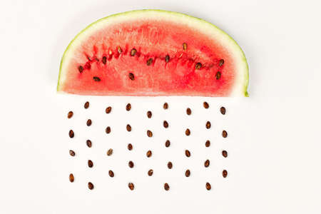 watermelon sliced white background with seeds like a rainの写真素材