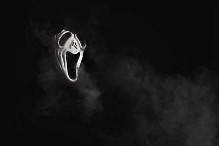 man in a terrible mask and black cloak cloud of vaporの写真素材