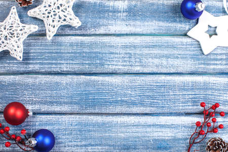 New Year background with berries, stars and Christmas cones on wooden backgroundの写真素材