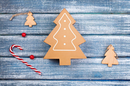 New Year background with wooden fir-trees and sweets on wooden backgroundの写真素材