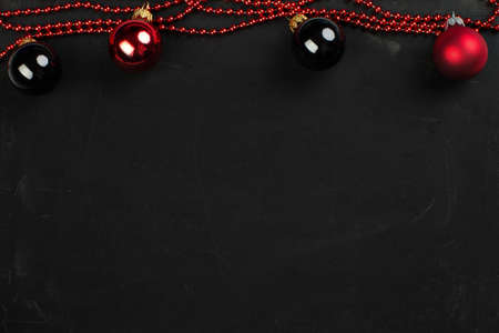 red and black christmas balls on a black backgroundの写真素材