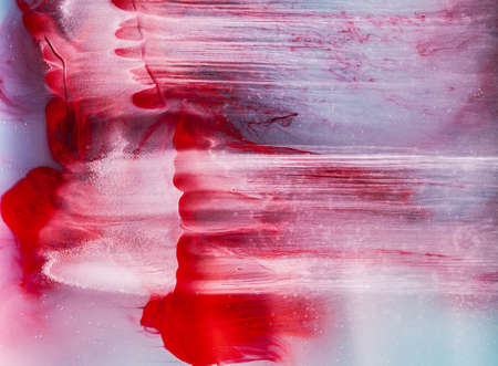 Color paint drops in water. Ink swirling underwater. Cloud of silky ink collision on white background. Colorful abstract smoke explosion animation. Close up camera view.の写真素材