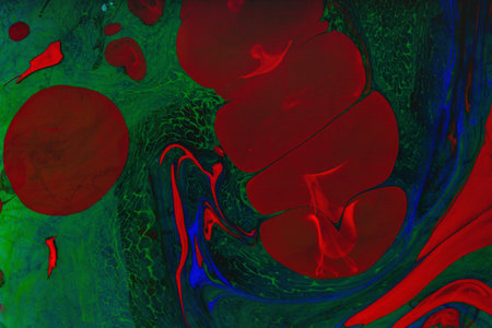 Color paint drops in water. Ink swirling underwater. Cloud of silky ink collision on black...