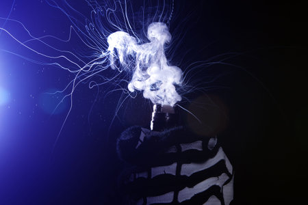 man in a skeleton suit holding a mod. Electronic Cigarette vape explosionの写真素材