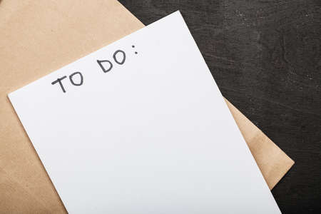 inscription to do on white sheet of paper on a dark wooden backgroundの写真素材