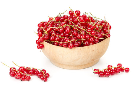ripe juicy currant branches in a plate on white table on a white background