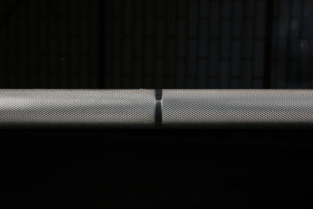 Barbell bar on the old gym floor