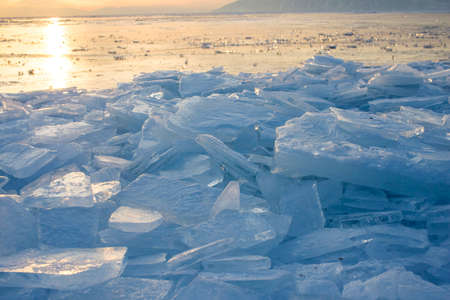 Ice of Baikal lake at sunset in Russiaの写真素材