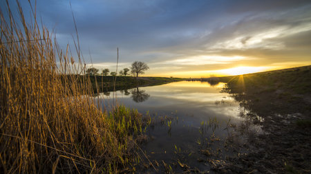 beautiful sunset at the river in the village in Russiaの写真素材