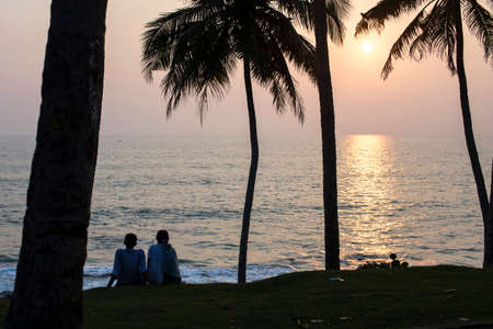 Couple in love on the ocean at sunset in Indiaの写真素材