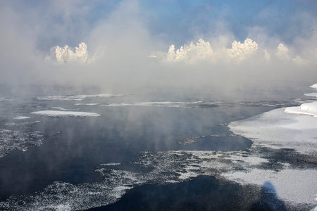 the mist over the river in the winter in Russia