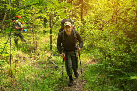 man with backpack hiking in forest, Europe