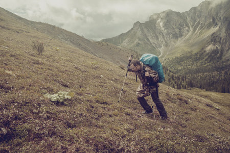 man climbs a mountain at the beautiful viewの写真素材