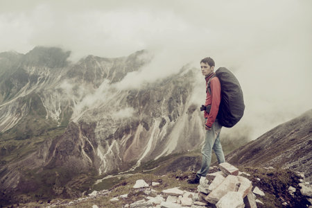 man climbs a mountain at the beautiful view