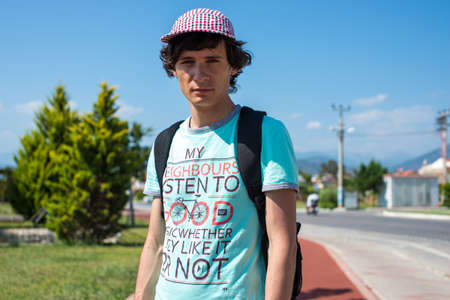 Young man with a backpack standing in European city. Outdoor. blue skyの写真素材