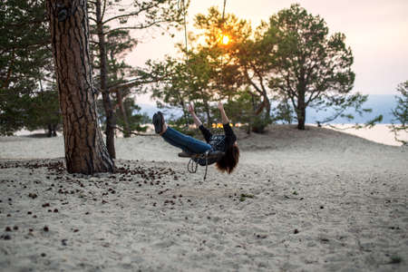 Beautiful girl swing on the beach on Olkhon island, Baikalの写真素材