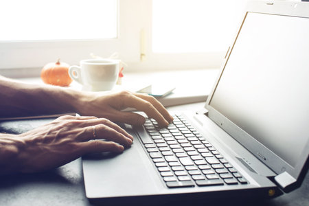 Cropped view of a male office worker. Close-up of busy hand typing on keyboard
