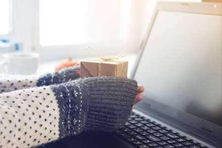 views of hands with gift box and laptop, the concept of e-shoppingの写真素材