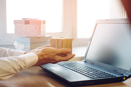 views of hands with gift box and laptop, the concept of e-shoppingの写真素材