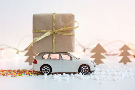 Toy car carries on the roof gift for Christmas and the new yearの写真素材
