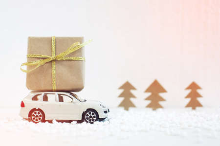 Toy car carries on the roof gift for Christmas and the new yearの写真素材