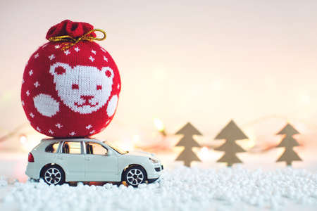 Toy car carries on the roof gift for Christmas and the new yearの写真素材