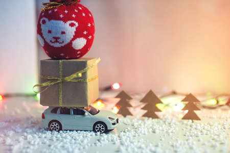 Toy car carries on the roof gift for Christmas and the new yearの写真素材