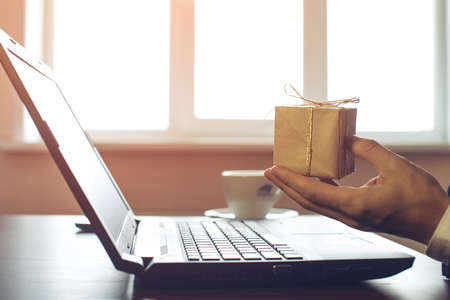 man businessman buying a gift online via credit card, close up view of his hands. the concept of online shopping.の写真素材