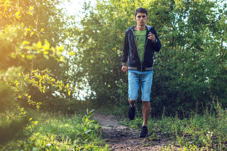 man on a morning jog in the forest, healthy lifestyleの写真素材