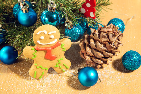 gingerbread man near Christmas tree with toys by garland, the concept of Christmas