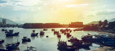 Fishing boats returning to port at sunset, Nha Trang, Vietnam.の写真素材