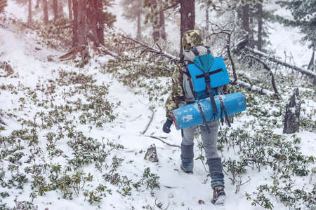 Winter landscape. Tourists come over the hill in the snow. Christmas. Low contrast. The color tintの写真素材