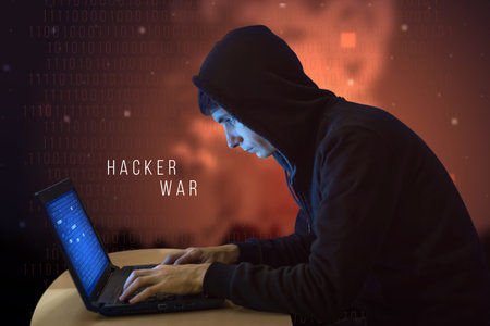 Hacker with laptop initiating the hacker attack, cyber war